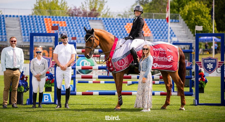A woman on a horse during a presentation