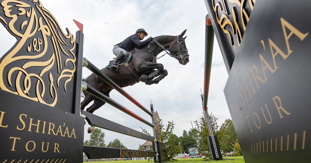 A man jumping a horse over a fence at Hickstead.