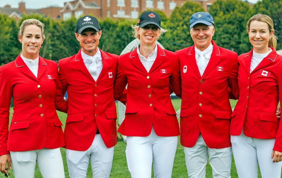 Five Canadian riders in red jackets.