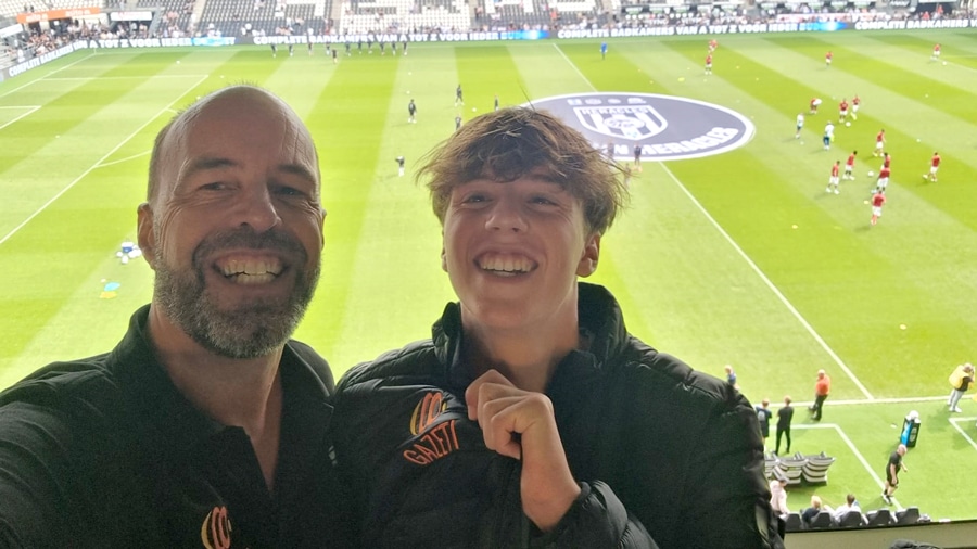 A man and his son at a soccer match.
