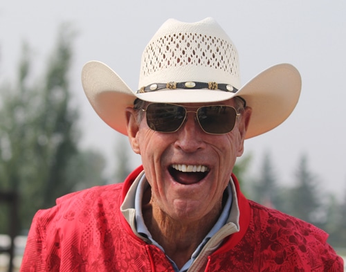 A smiling man wearing a cowboy hat.