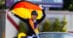 A woman in a convertible, waving a German flag.