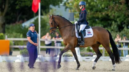 A caller and a blind para dressage rider.