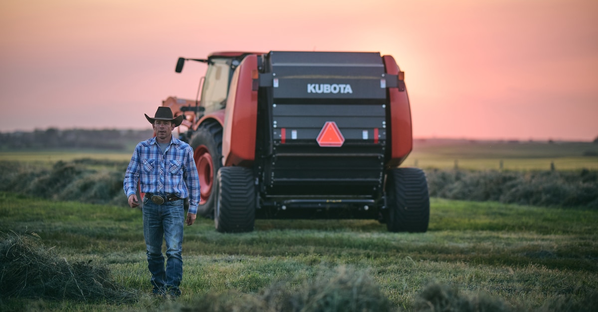 A man in a field with a tractor.
