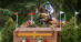 A woman jumping a cross-country fence on a bay horse.