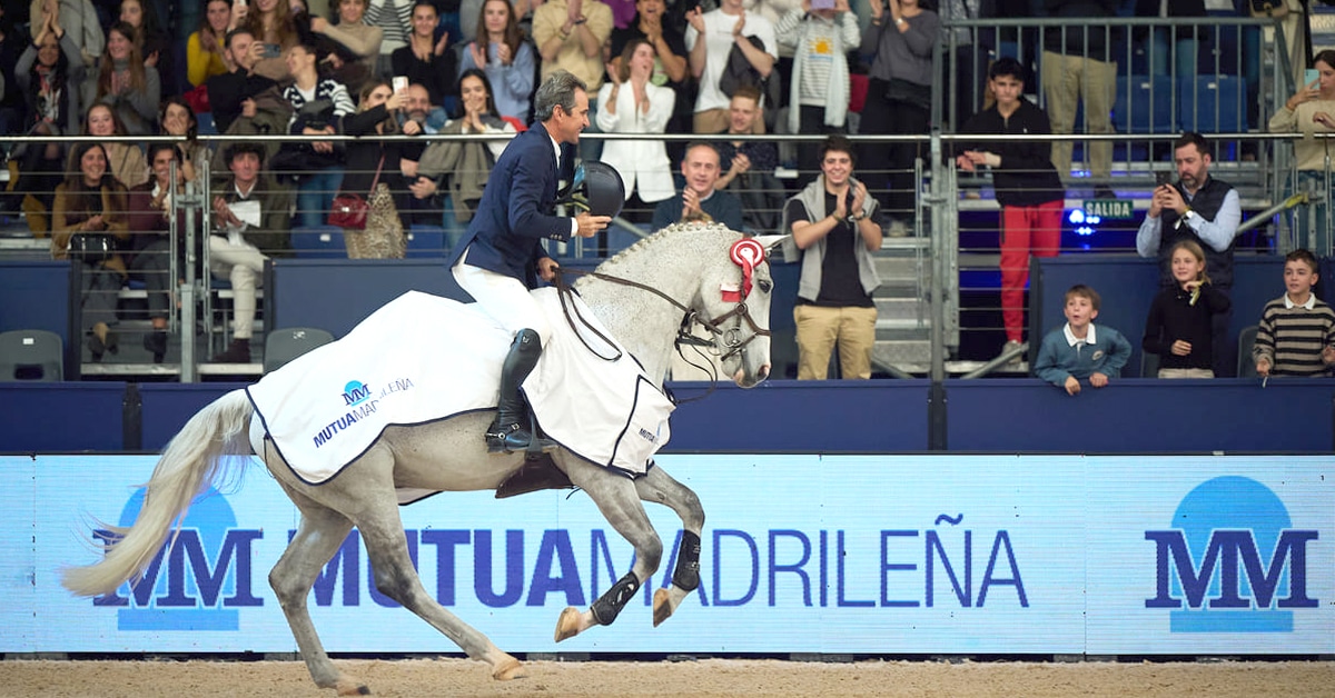 A man on a grey horse during a victory lap in Madrid.