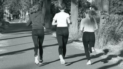 Three women jogging in a park.