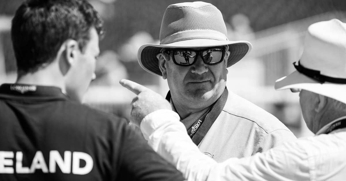 Black and white photo of a man wearing a hat.