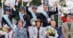 A team on the podium waving flowers.