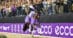 A woman riding a dark bay dressage horse during a victory lap.