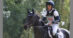 A man riding a dark bay eventing horse in France.