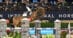 A man on a bay horse jumping a fence at a horse show in Maryland.