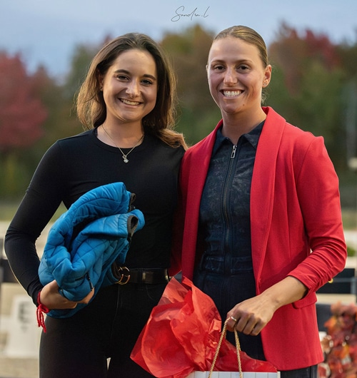 Two smiling women posing for a photo.