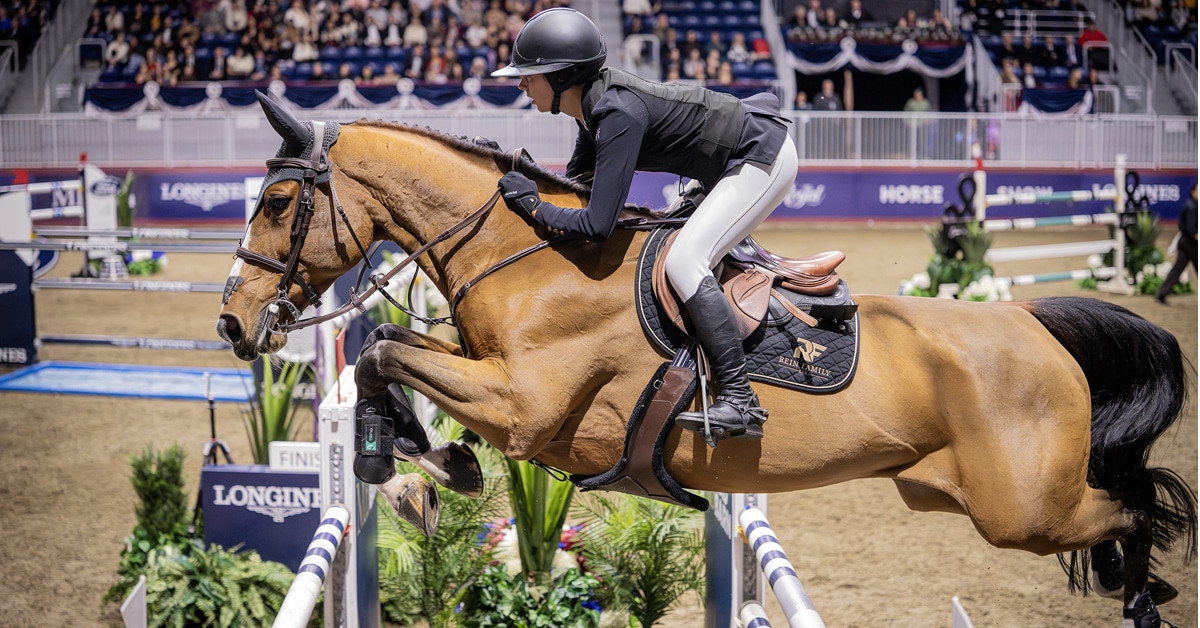 A light bay mare jumping a fence at the Royal.