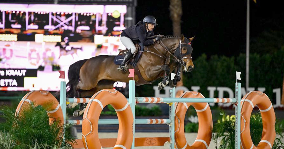 A woman jumping a bay mare over a fence in California.