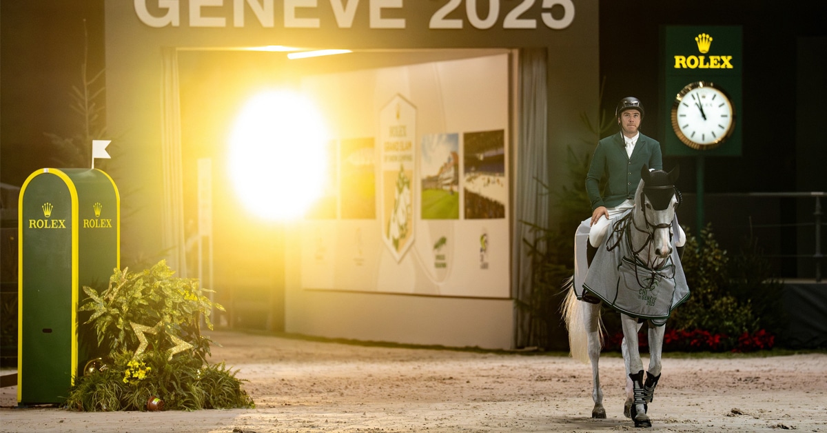 A man on a grey horse walking into the arena in Geneva.