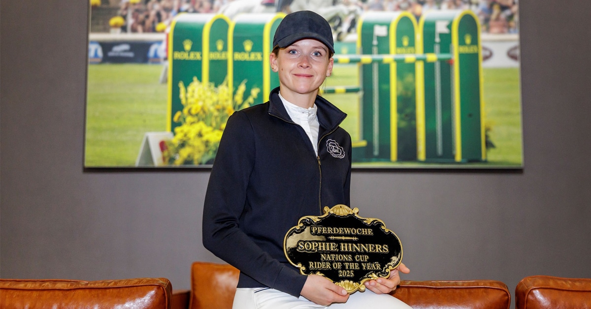 A woman holding a plaque.