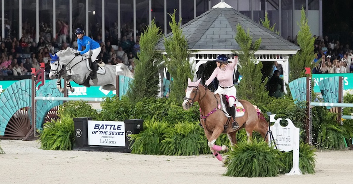 A man and a woman on horseback racing to the finish of a jumping course.