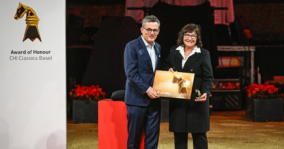 A man handing a woman an award on a stage.