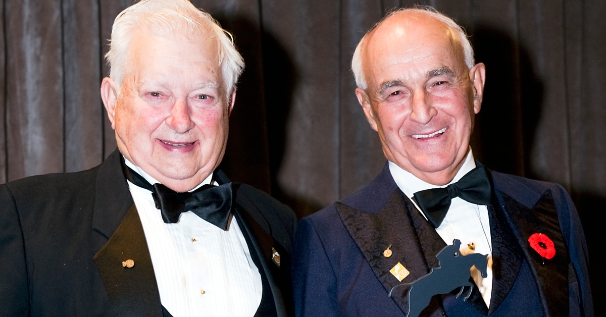 Two smiling older gents wearing tuxes.