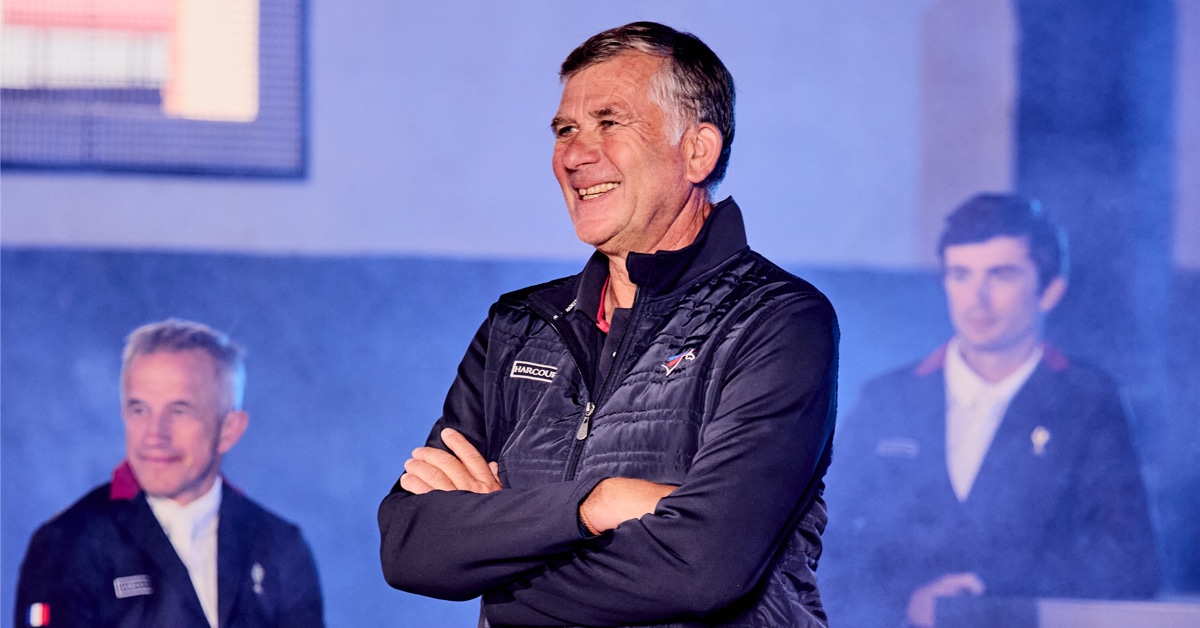 A smiling man in a French team jacket.