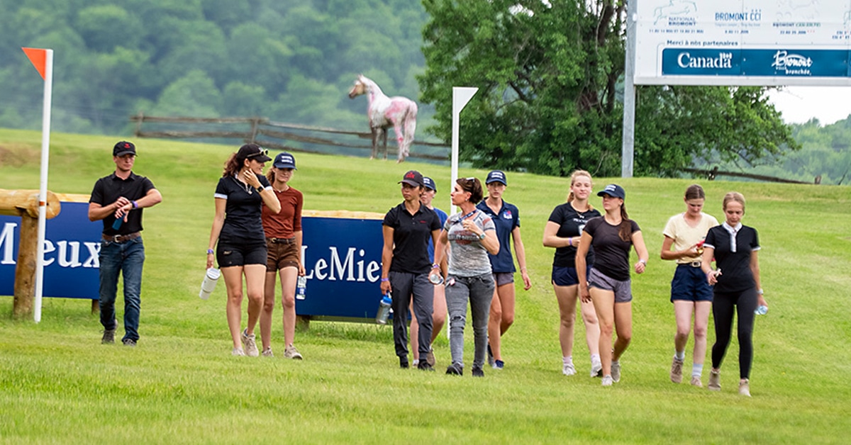 A group of people walking the cross-country course at Bromont.