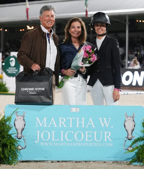 A man and two women during a ring presentation.