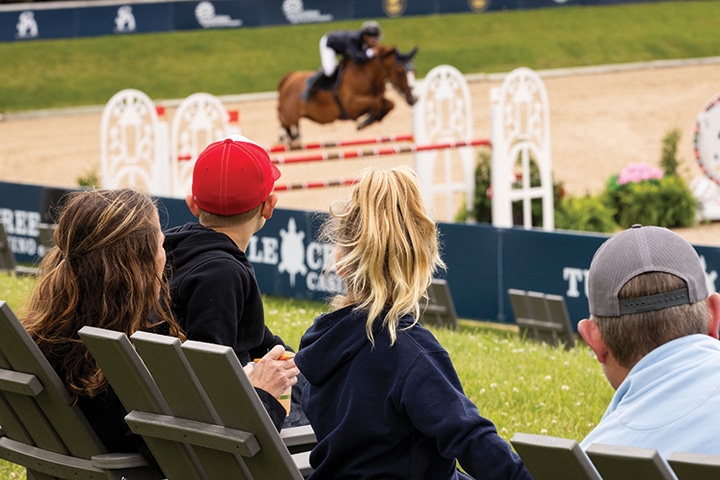 Spectators watching a jumping class.