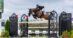 A woman jumping a bay horse over a fence in Florida.