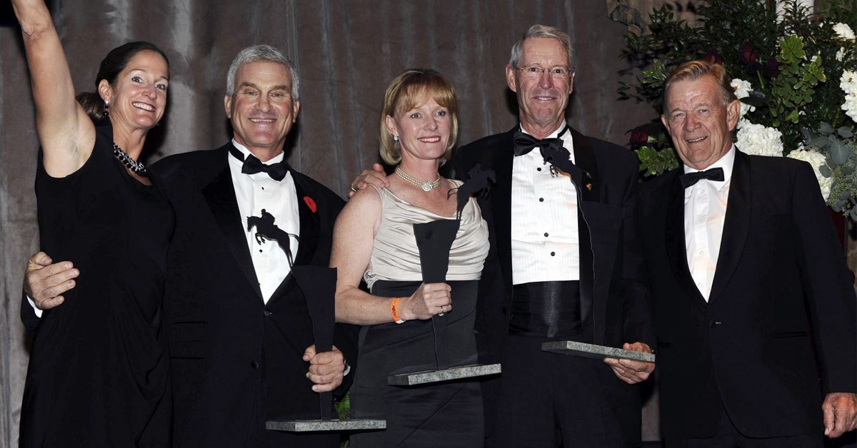 A group of people on an awards stage.