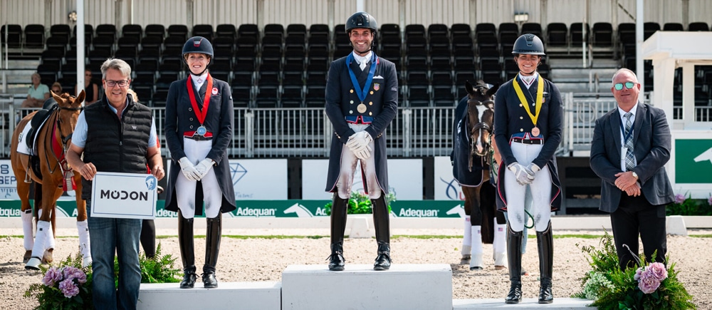 Three dressage rides on a podium in Florida.