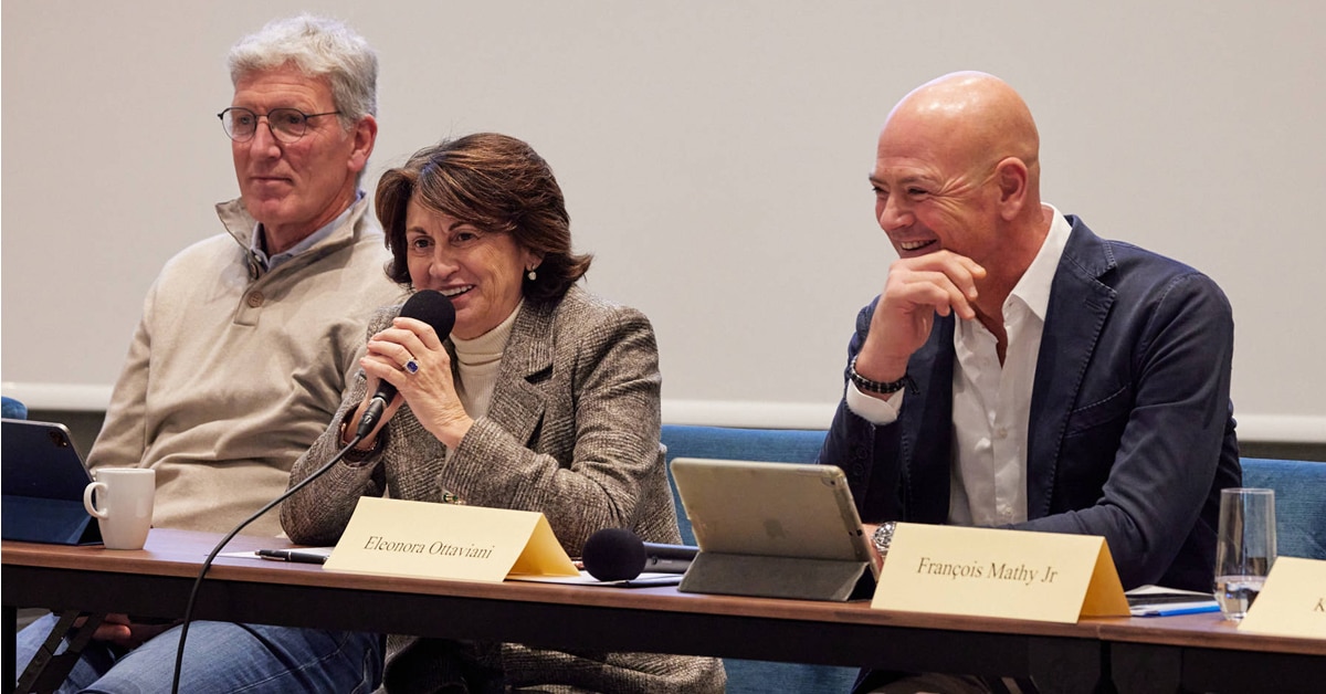 Two men and a woman leading a meeting.