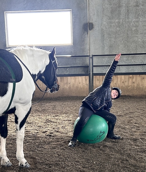 A woman stretching on an exercise ball.