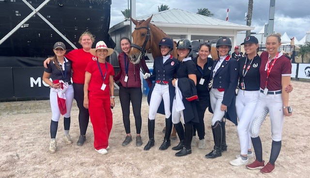 A group of riders at a dressage show.