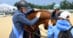 A woman petting a horse after winning a class.