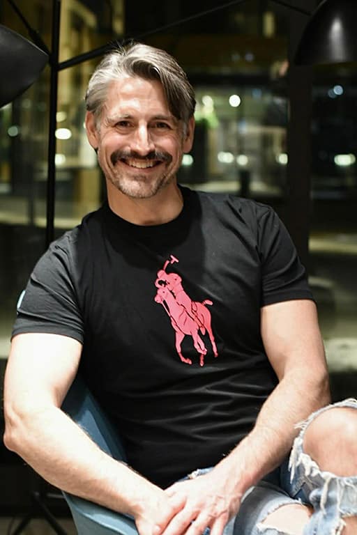 A smiling man with a mustache.