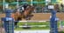 A woman jumping a bay horse over a fence at Spruce Meadows.