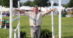 A man standing between jump standards on a course.