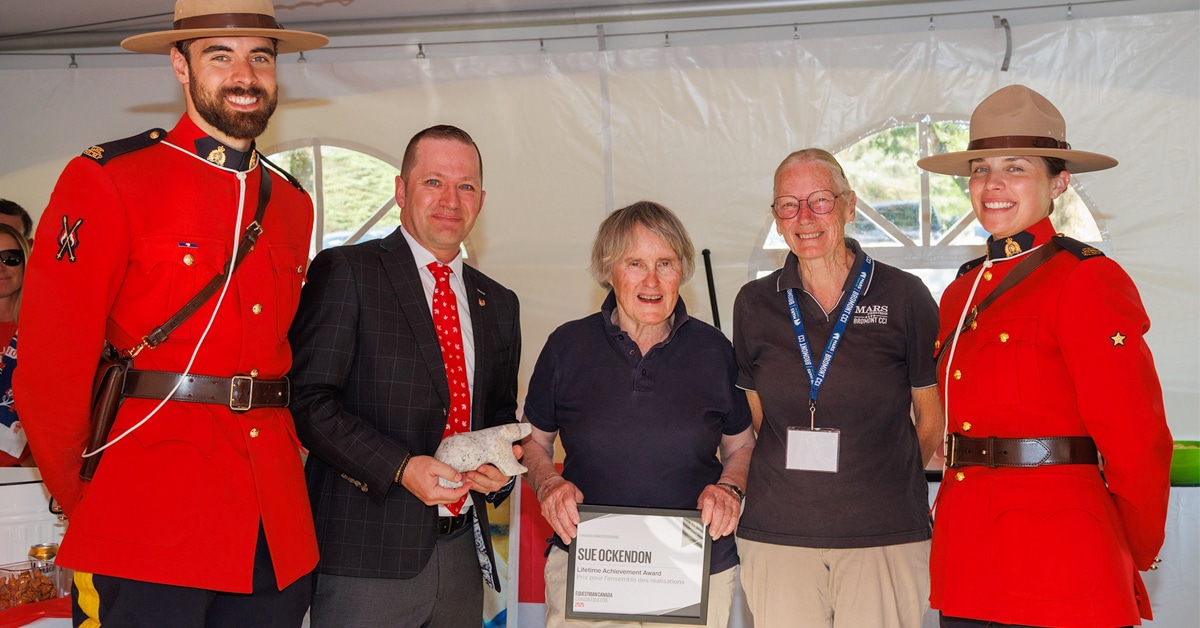 RCMP members with 3 people during an awards ceremony.
