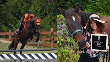 A woman jumping a bat horse over a fence - the woman and horse standing with a sign.