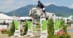 A man jumping a grey horse over a fence at Lake Placid.