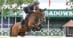 A man jumping a bay horse over a fence at Spruce Meadows.