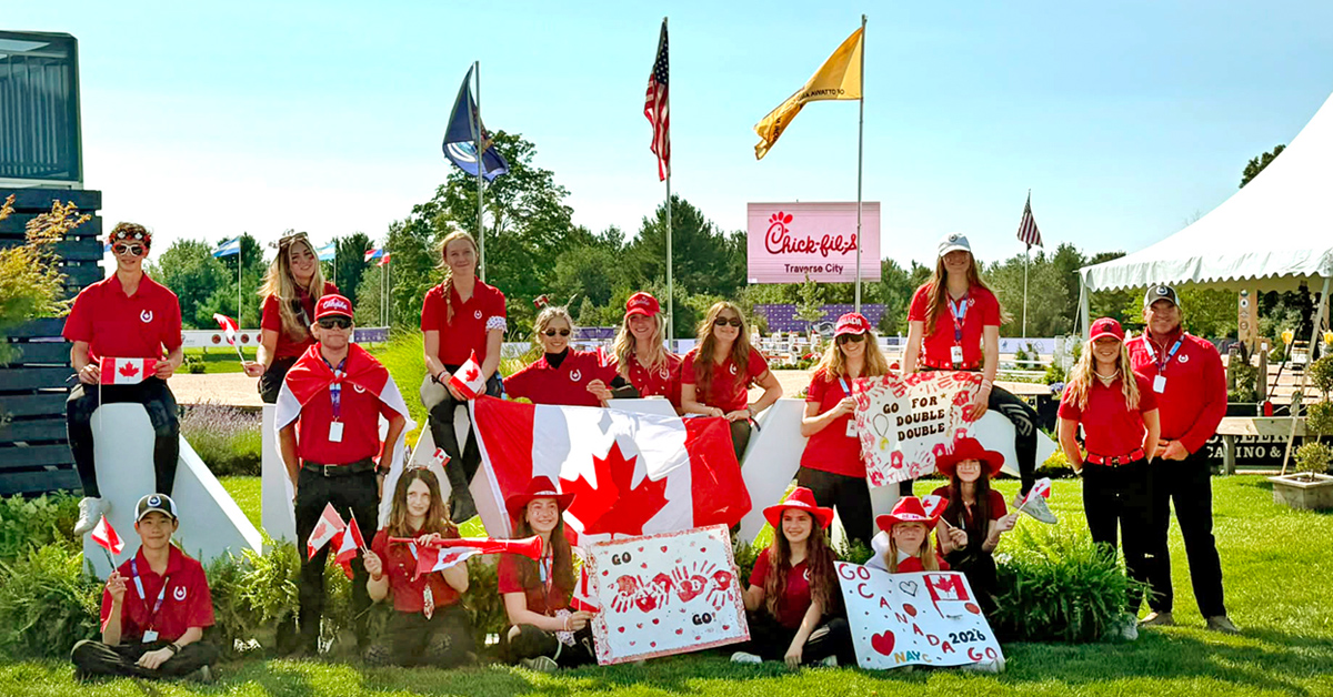 A group of young riders with Canadian flags.