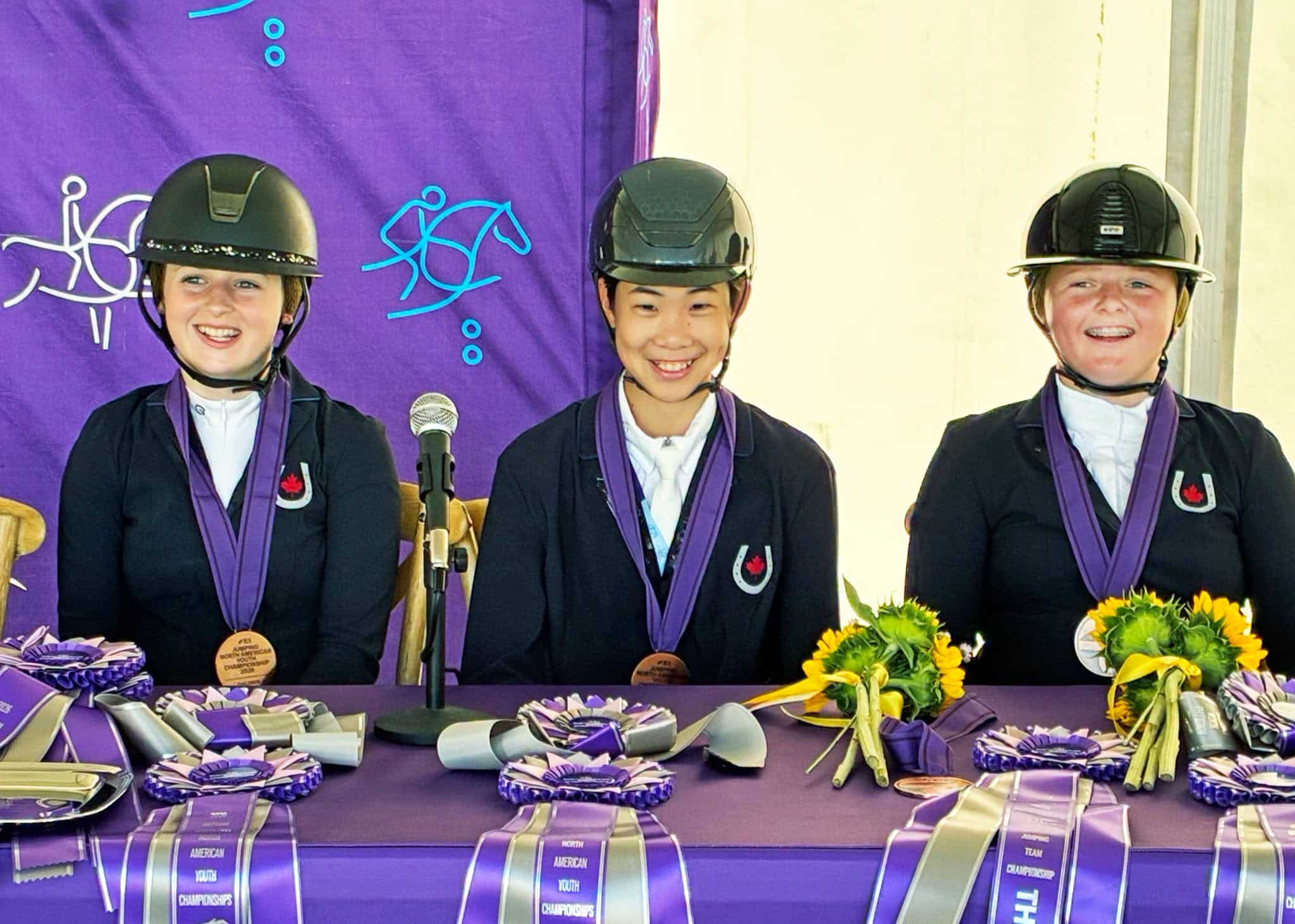Three riders during a press conference. 