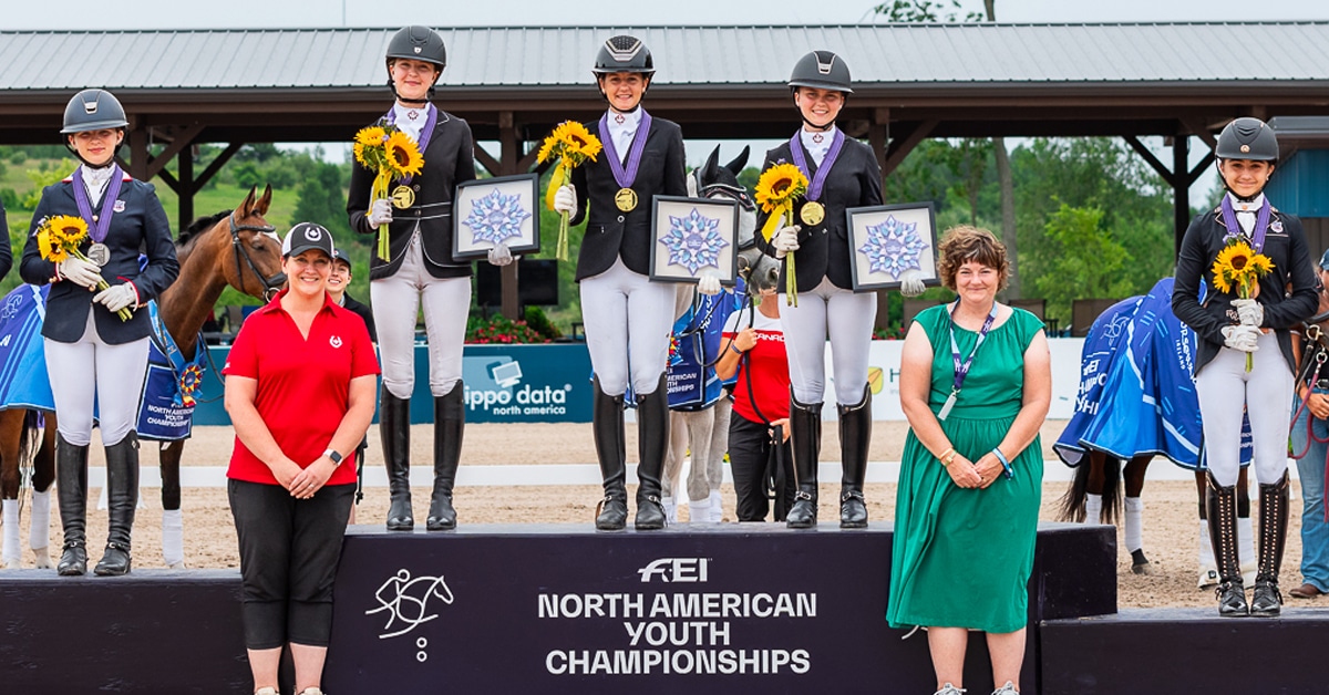 A team of riders standing on a podium.