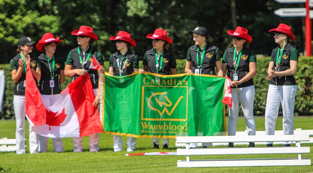 A team of young people wearing red cowboy hats.