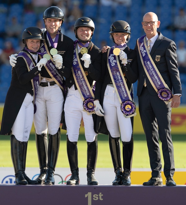 A team of riders standing on a podium.