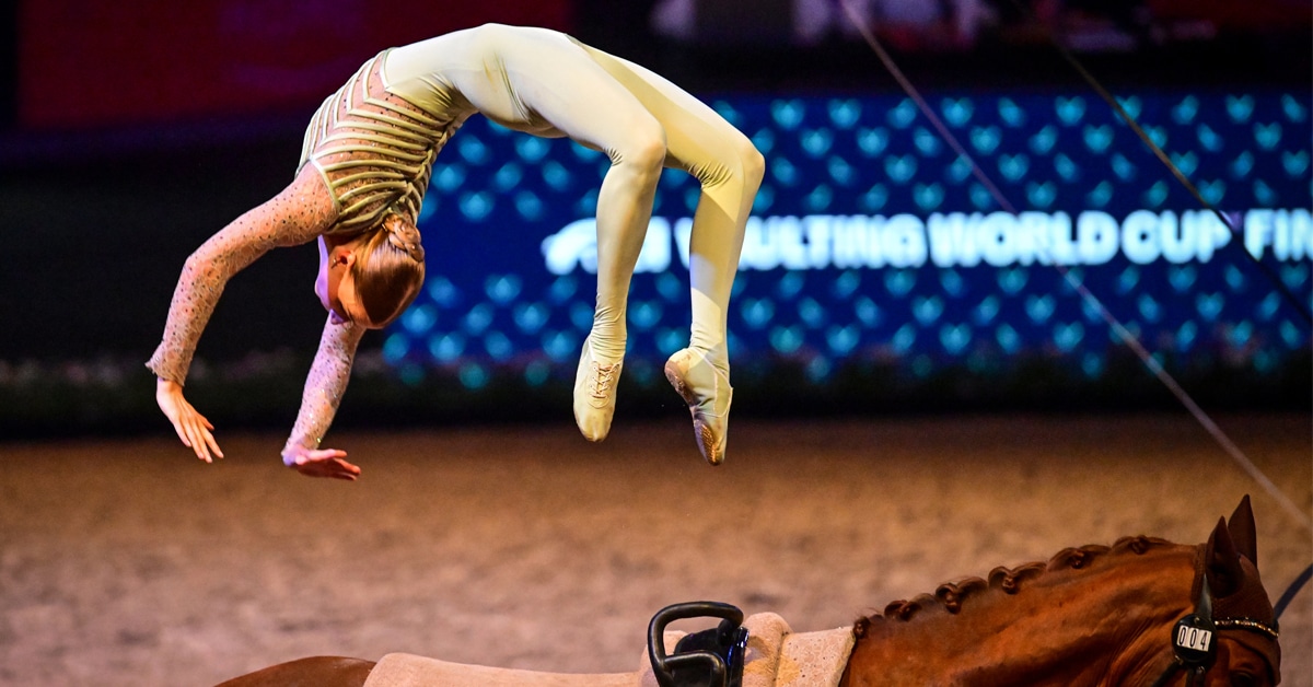 A female vaulter doing a backflip.