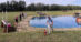 A man measuring a water jump with a wheel.