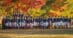 A group of dressage riders in an autumn setting.